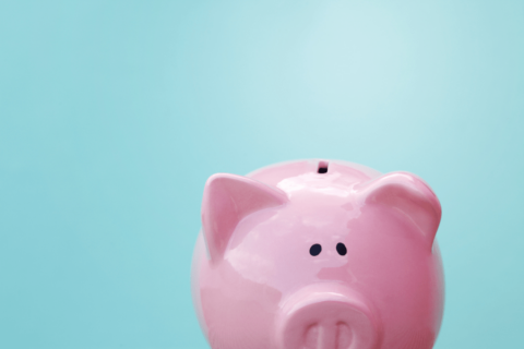 Do you know the real cost of your building management? Image depicts a pink piggy back peaking up from the bottom of the screen, against a pale blue background.