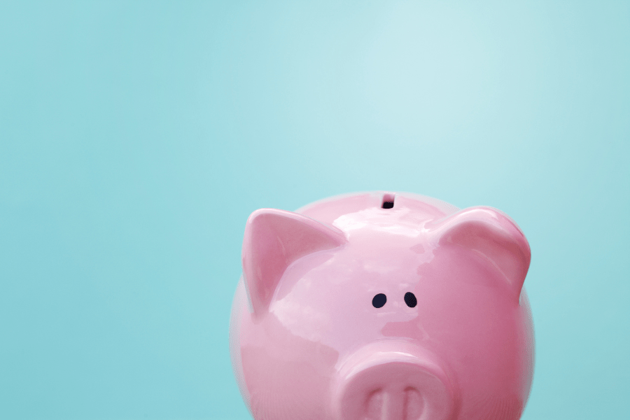 Do you know the real cost of your building management? Image depicts a pink piggy back peaking up from the bottom of the screen, against a pale blue background.